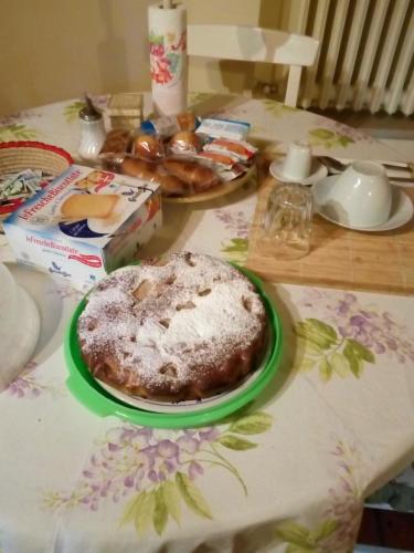 a table with a cake on a plate on a table at Albarosa in Ruvo di Puglia