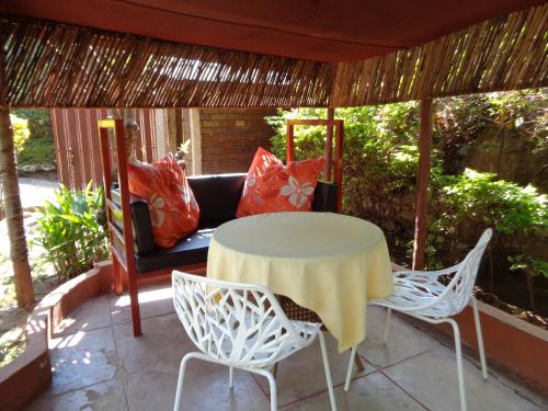 a patio with a table and chairs and a couch at The Clarice House in Kisumu