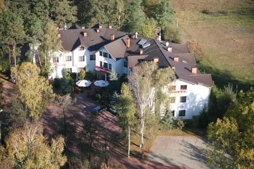 an aerial view of a large house in the forest at Hotel Relaks in Wola Ducka