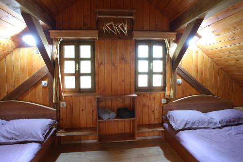 a bedroom with two beds in a wooden cabin at Vineyard cottage Zidanca med vinogradi in Otočec