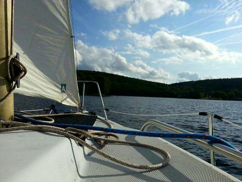 a sail on a boat on a body of water at Hotel Restaurant La Caravelle in Peyrat-le-Château