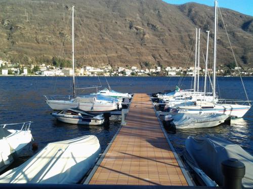 a group of boats docked at a dock in the water at Old Factory in Omegna