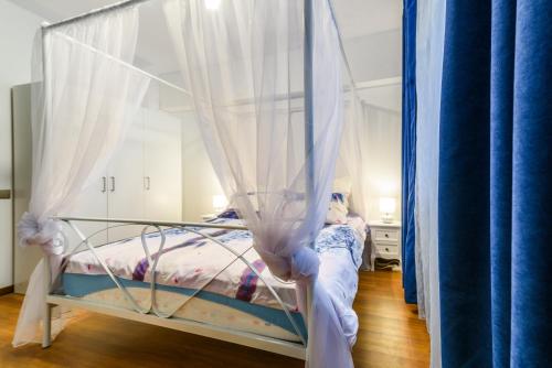 a little girl is in a canopy bed in a room at Bucharest Pedestrian Old Town 3 Bedrooms by Orchid Garden in Bucharest