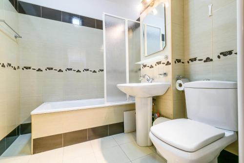a bathroom with a toilet and a sink and a shower at Bucharest Pedestrian Old Town 3 Bedrooms by Orchid Garden in Bucharest