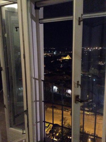 an open window with a view of a city at night at Old castle S. Croce in Cagliari