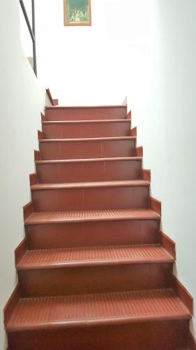 a set of brown stairs in a building at CH Lar Alojamiento in Mendoza