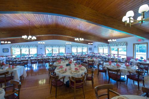 una sala per banchetti con tavoli e sedie bianchi di Lukans Farm Resort a Hawley