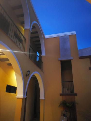 a building with arches on the side of it at Casa Sisal Valladolid Yuc in Valladolid