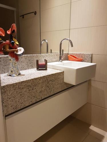 a bathroom counter with a sink and a mirror at Landscape Beira Mar - 1804 Gold B in Fortaleza