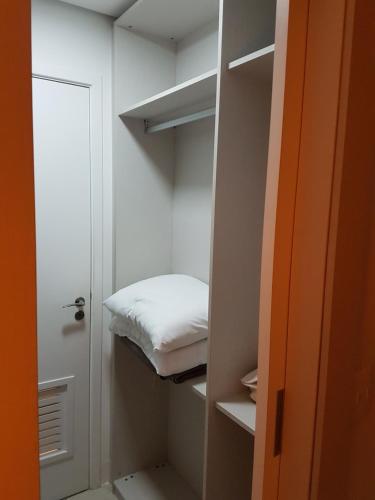 a small room with a bed in a closet at Landscape Beira Mar - 1804 Gold B in Fortaleza
