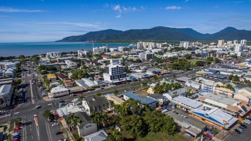 an aerial view of a city with the ocean at Alivio Hotel Cairns in Cairns
