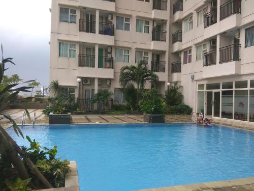 a swimming pool in front of a building at DSR Margonda Residence 3 Apartment in Depok
