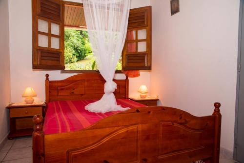 Postel nebo postele na pokoji v ubytování Les Fleuris 972