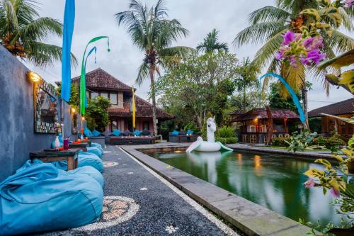 a pool at a resort with blue inflatables at In Da Lodge in Ubud