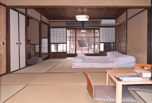 a living room with a bed and a table at Veada in Kyoto