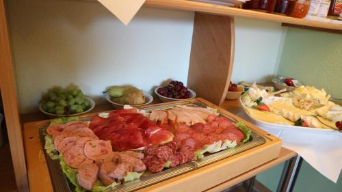 a buffet of different types of food on a table at Hus op de Diek in Sankt Peter-Ording