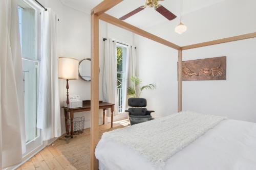 a bedroom with a bed and a desk and a window at The Local Hotel in Fremantle