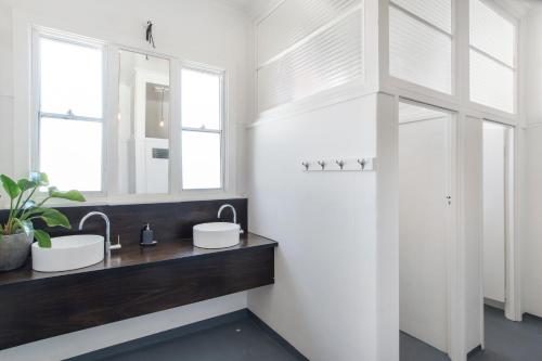 a bathroom with two sinks and a mirror at The Local Hotel in Fremantle