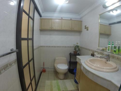 a bathroom with a toilet and a sink at Casa Impiana in Kuantan