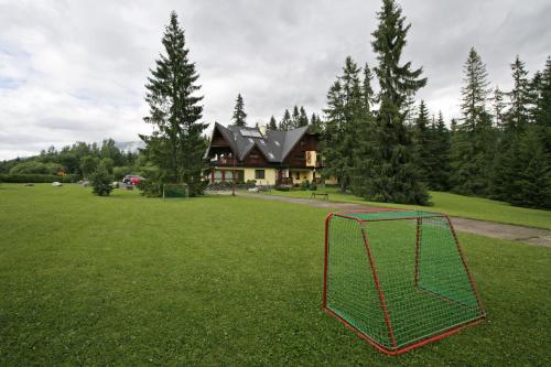 a soccer goal in a field in front of a house at Penzión Ingrid in Štrbské Pleso