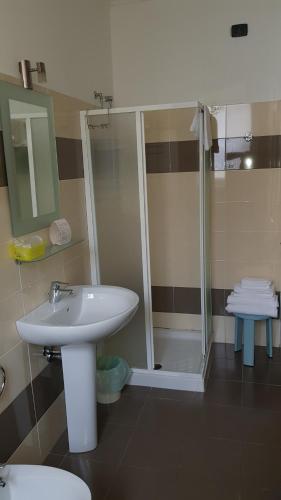 a bathroom with a sink and a shower at Hotel Principe in Casale Monferrato
