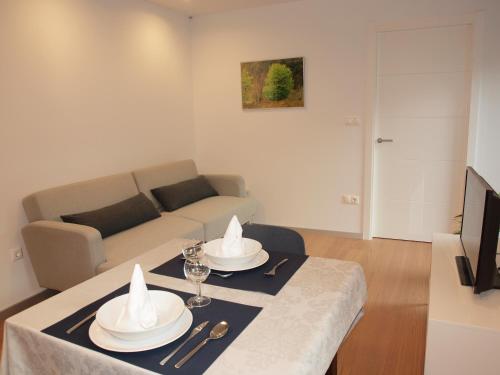a living room with a table and a couch at Mendialdea Amaiur Baztán in Maya del Baztán