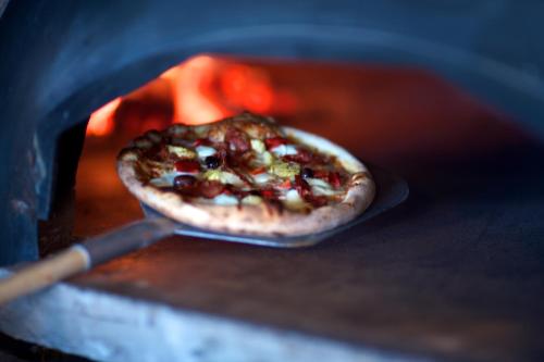 a pizza is being cooked in an oven at Örum 119 in Löderup