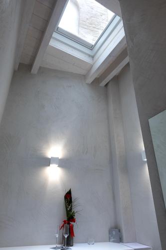 a skylight in a white room with a window at BORGOBELTRANI in Trani