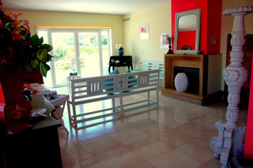 a living room with a glass table and a fireplace at CAMINHOS DE SANTIAGO - VillaMaria BEACH HOUSE in Leça da Palmeira