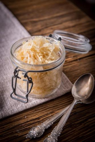 a glass jar of food on a table with a spoon at Berry House in Vigolo Vattaro
