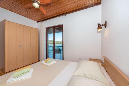 a bedroom with a bed and a cupboard at Apartment Lidija in Tisno