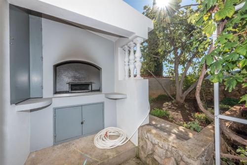 a white wall with a fireplace in a house at Apartments Danica in Tisno