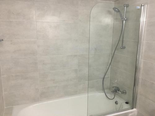 a bathroom with a shower with a glass door at Diamond Townhouse 17 in Paphos