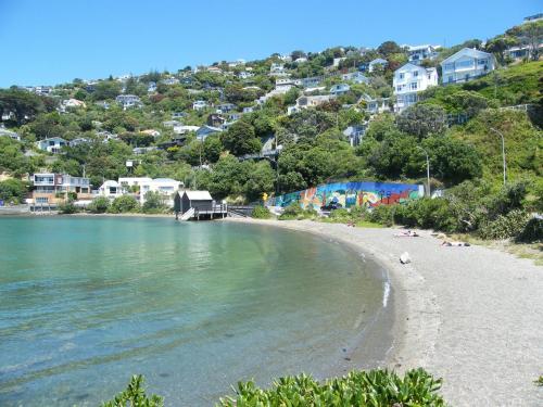 a beach with a group of people laying on the beach at Bella Vista Motel Wellington in Wellington