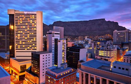 a view of a city with a mountain in the background at Southern Sun Cape Sun in Cape Town
