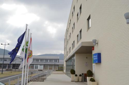 a building with flags in front of it at Holiday Inn Express Vitoria by IHG in Vitoria-Gasteiz