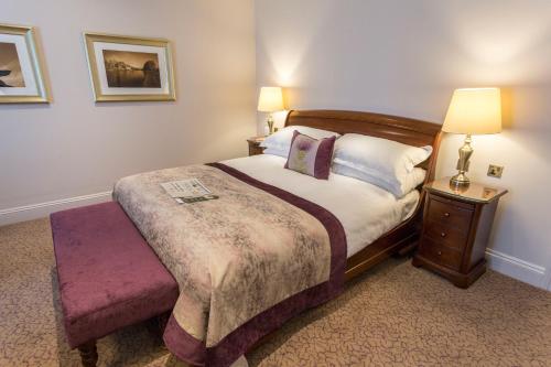
a bedroom with a bed and a lamp at Swan's Nest Hotel in Stratford-upon-Avon

