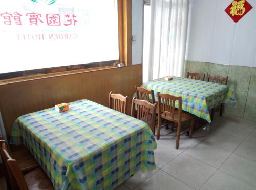 a restaurant with two tables and chairs and a window at Qufu Garden Hotel in Qufu
