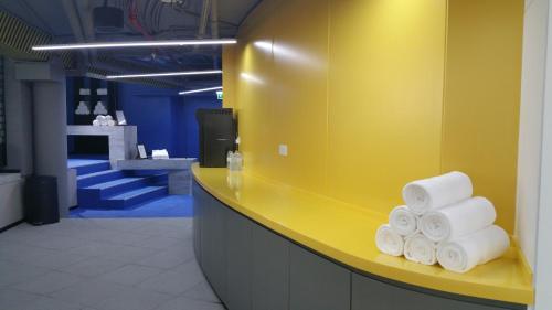 a pile of towels on a yellow counter in a store at Millennium Airport Hotel Dubai in Dubai