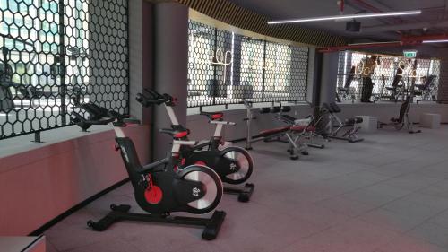 a row of exercise bikes in a gym at Millennium Airport Hotel Dubai in Dubai