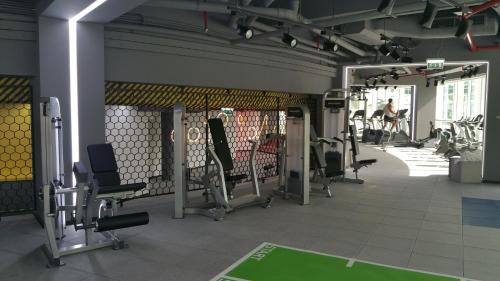 a gym with several treadmills and machines at Millennium Airport Hotel Dubai in Dubai