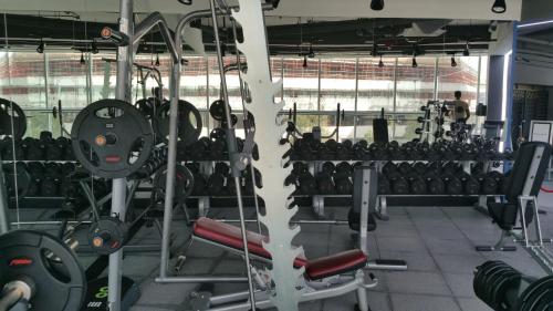 a gym with a lot of equipment in it at Millennium Airport Hotel Dubai in Dubai