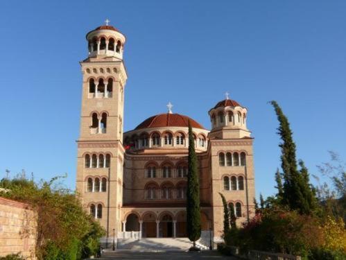 a large building with two towers on top of it at Senia Studios in Agia Marina Aegina