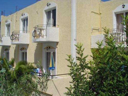 a building with a flag in front of it at Senia Studios in Agia Marina Aegina