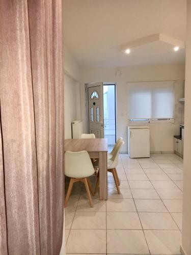 a dining room and kitchen with a table and chairs at Studios Katerina in Iraklitsa