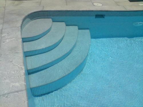 a swimming pool with steps in the water at Porto Sisi Hotel Apartments in Sissi