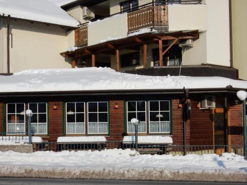 a building with snow on top of it at Garni Hotel Terano in Maribor in Maribor
