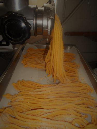 a pasta being beingprocessed by a pasta machine at Hotel Ristorante Miramare in Pesaro