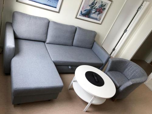 a living room with a couch and a table at Grand Hotell Bollnäs in Bollnäs