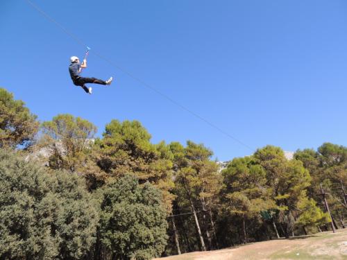 a man flying through the air while riding a parachute at Hotel Antequera Rural Fortes La Nuit in Mollina